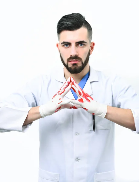 Surgeon with hands in blood. Man with beard in uniform. — Stock Photo, Image
