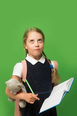 Okul üniformalı çocuk. Örgülü ve düşünceli yüzlü bir kız.