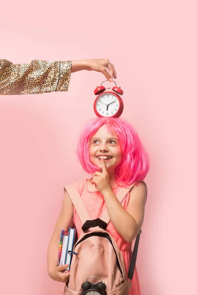 Back to school concept. Girl with wig in pink dress — Stock Photo, Image