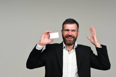 Sakallı takım elbiseli adam beyaz boş kartvizit tutar