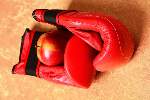 Boxing gloves in red color. Professional box fight and dieting