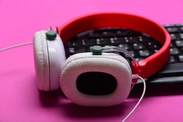 Headphones and black keyboard. Music and call center concept