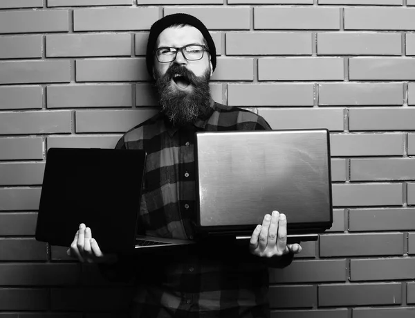 Barbudo brutal caucasiano hipster segurando laptops — Fotografia de Stock