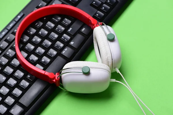 Headphones and black keyboard. Sound recording and technology idea