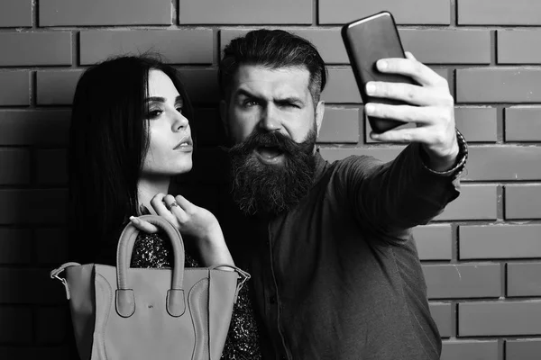 Homem barbudo e mulher muito sexy com saco e telefone — Fotografia de Stock