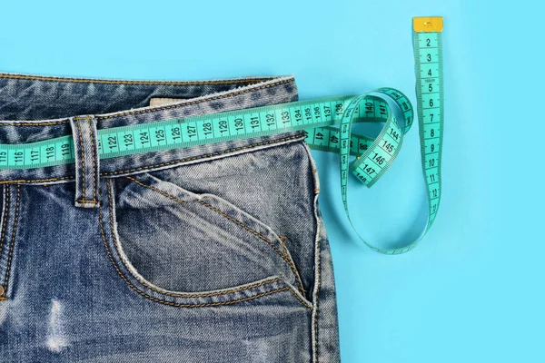 Losing weight concept: measure tape around jeans