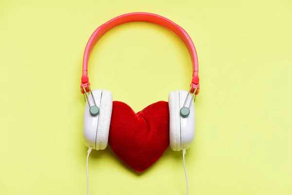 Headphones in white and red color with soft toy heart — Stock Photo, Image