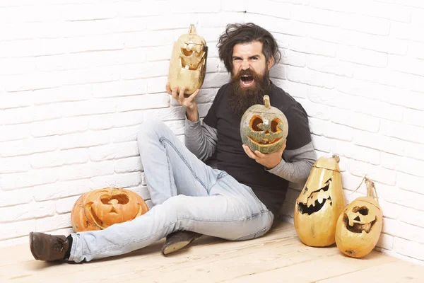 Hipster with golden pumpkins — Stock Photo, Image