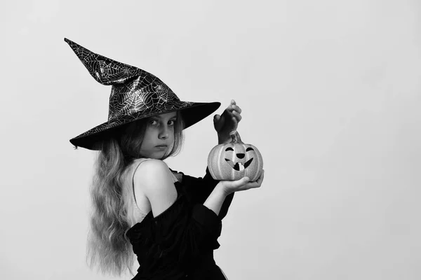 Criança em traje de bruxa e jack o lanterna — Fotografia de Stock