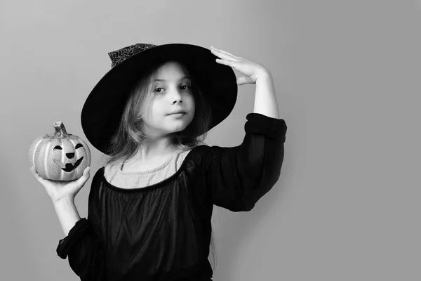 Criança de chapéu de bruxa preta, vestido e rosto sorridente — Fotografia de Stock