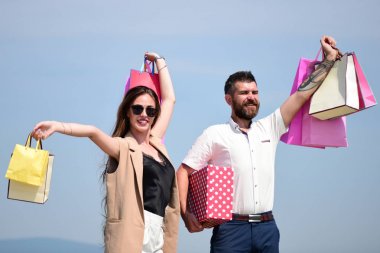 Man with beard and long haired woman hold shopping bags clipart