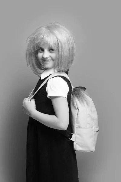 Girl with backpack in light color. Kid with happy face — Stock Photo, Image