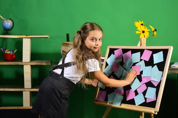 Crianças e material escolar no fundo da parede verde — Fotografia de Stock