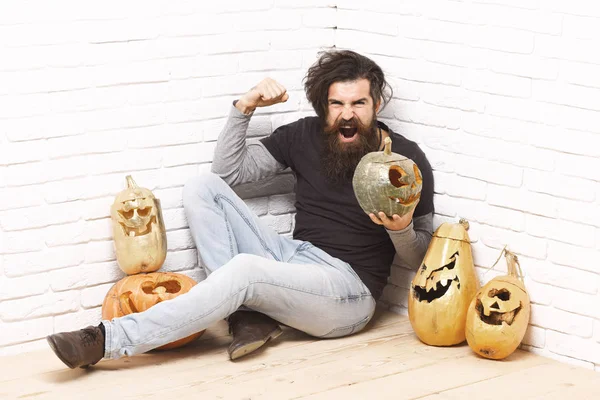 Hipster with golden pumpkins — Stock Photo, Image