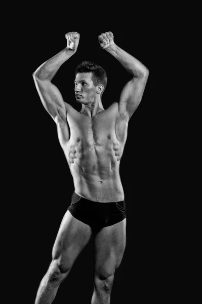 Athletic bodybuilder pose in pants. — Stock Photo, Image