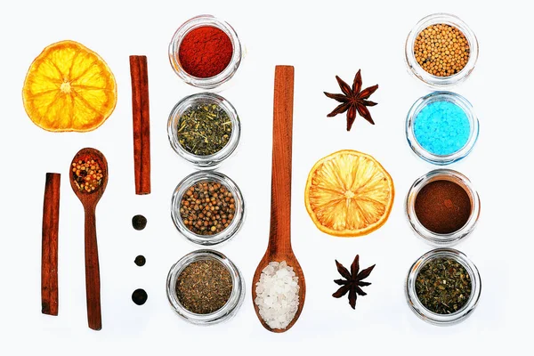 Various spices in spoons, jars, dried lemon on white background — Stock Photo, Image