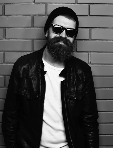 Bearded brutal caucasian hipster holding in glasses — Stock Photo, Image
