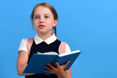 Okul üniformalı, örgülü bir öğrenci. Mutlu yüzlü kız.