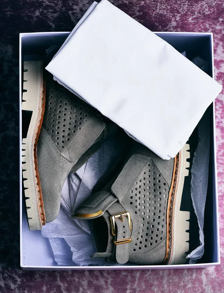 Womans grey suede boots with white sole in shopping box — Stock Photo, Image