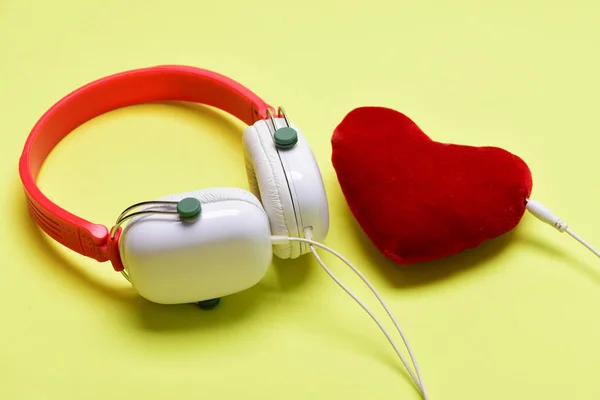 Leisure, music and love concept. Headphones in white and red — Stock Photo, Image