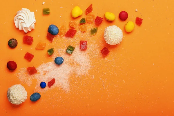 Candies on orange background — Stock Photo, Image