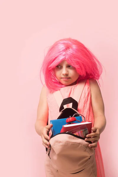 Pupil with scared face expression, isolated on light pink background — Stock Photo, Image