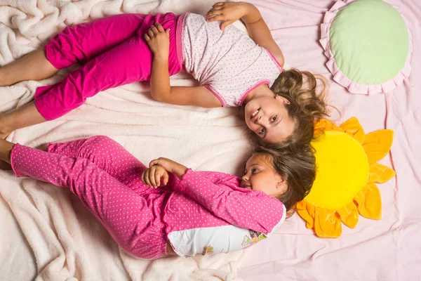 Childhood, party and happiness concept. Kids in pink pajamas — Stock Photo, Image