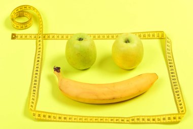 Muz ve elma çerçeve ile gülümseyen ifade yapmak