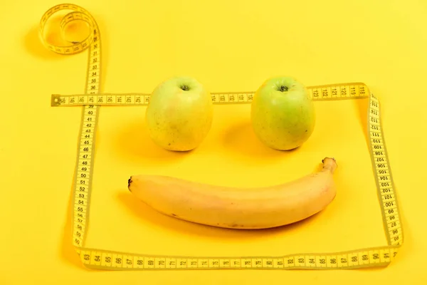 Face with smile made of fruit framed with flexible ruler — Stock Photo, Image