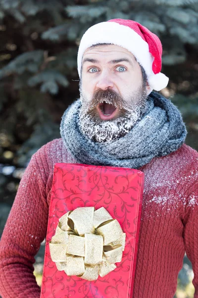 Handsome santa man with gift — Stock Photo, Image