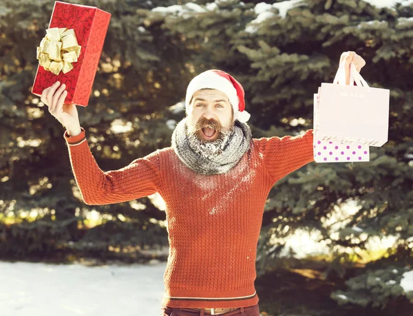 Handsome santa man opens presents — Stock Photo, Image