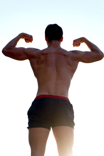 Uomo che mostra il corpo muscolare, vista posteriore — Foto Stock