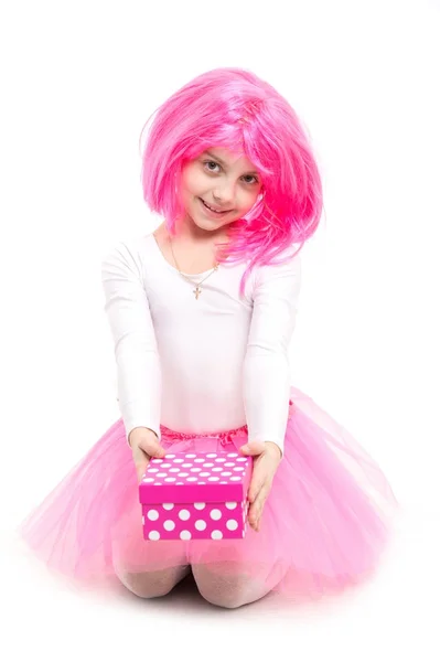 Small girl with gift box with red bow in pink skirt. — Stock Photo, Image