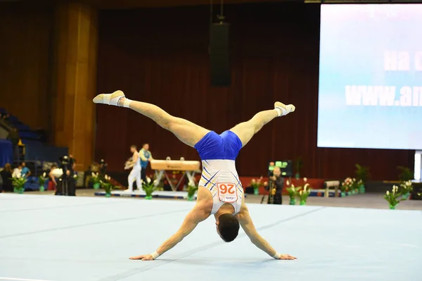 Male gymnast performing during competition — Stock Photo, Image