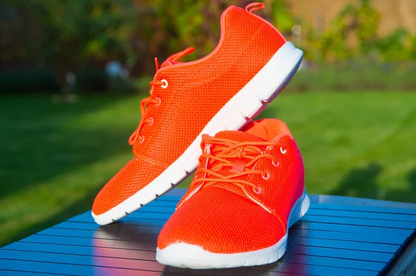 Sports shoes sneakers bright orange color.