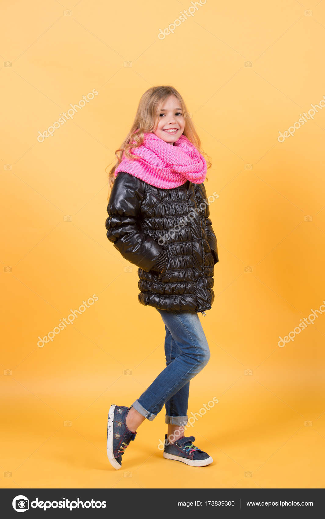 Kid With Long Blond Hair Black Coat Scarf Jeans Sneakers