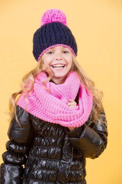 Şapkalı kız, pembe atkı, turuncu arka planda siyah ceket.