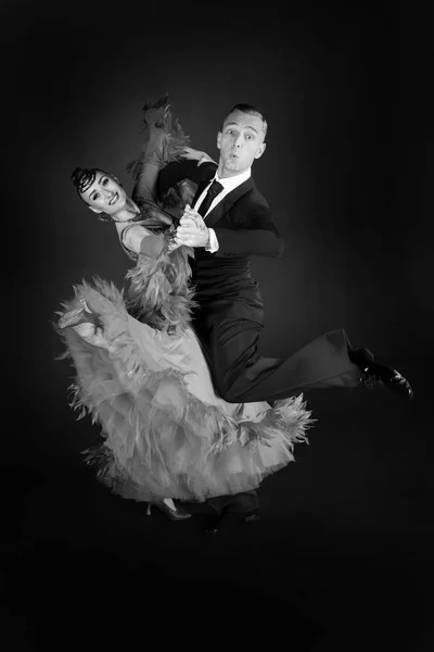 ballrom dance couple in a dance pose isolated on black background