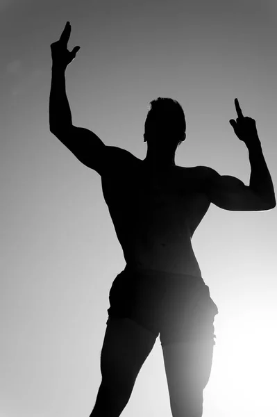 Silhouette of strong man — Stock Photo, Image