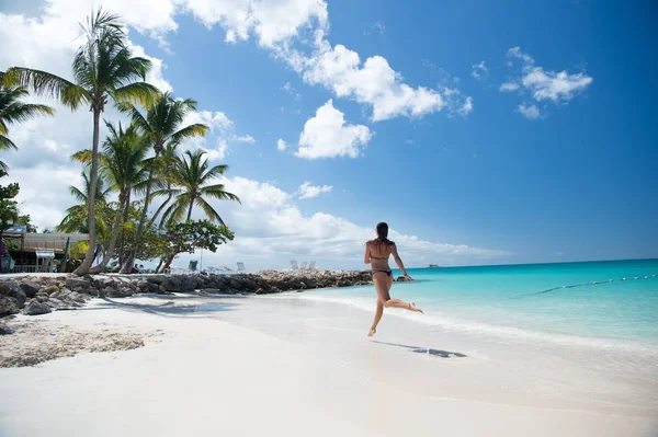 Chica ejecutar en la playa tropical en st johns, antigua — Foto de Stock