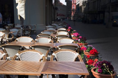 Masa, sandalye ve çiçekler tencere kaldırım kafe