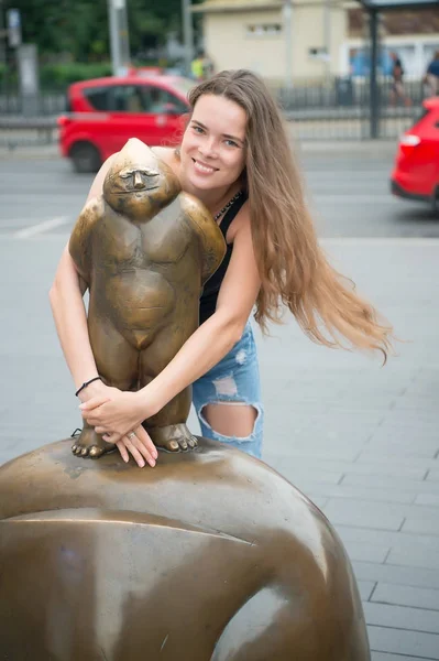 Mulher sorrir em bronze estátua masculina em wroclaw, polônia — Fotografia de Stock