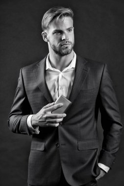 Resmi kıyafetli, cep telefonlu bir adam..