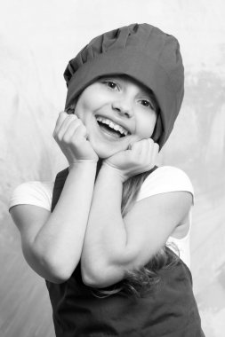 küçük kız Şef gülen surat önlük ve şapka ile