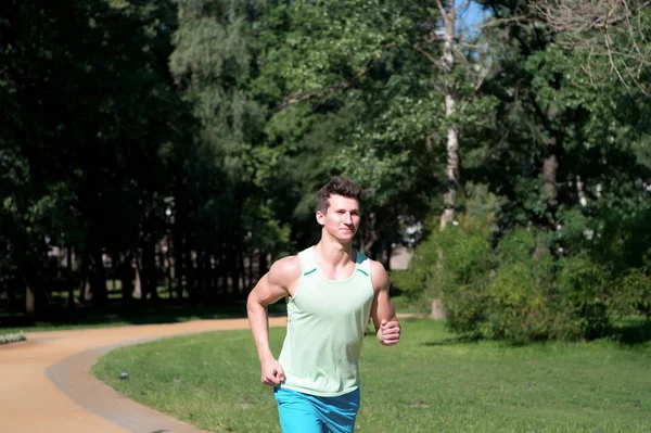 El hombre corre en el parque en el soleado día de verano —  Fotos de Stock