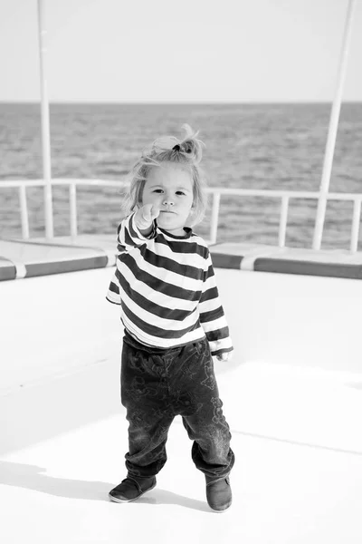 Little baby captain on boat on summer cruise, nautical fashion — Stock Photo, Image