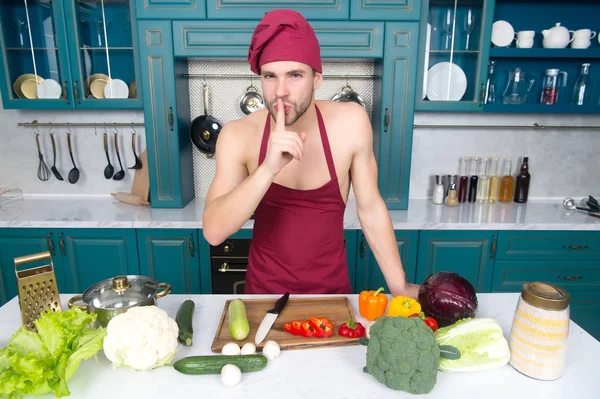 Macho in chef hat, apron put finger on lips in kitchen — Stock Photo, Image