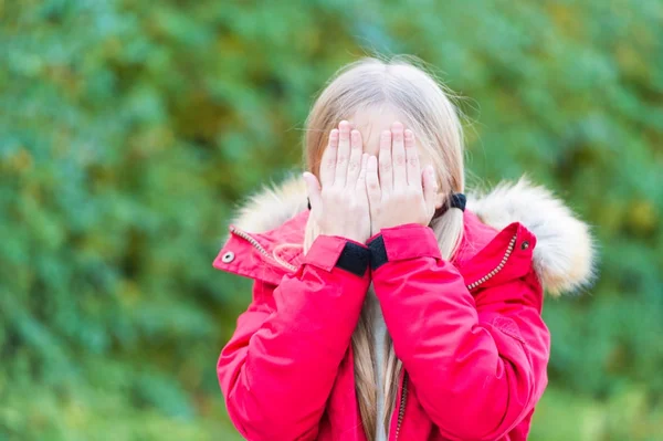 Κορίτσι απόκρυψη πρόσωπο με τα χέρια σε ειδυλλιακή μέρα του φθινοπώρου — Φωτογραφία Αρχείου