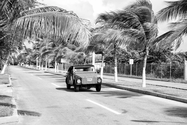 Orange car with man driver on road, Cozumel, Mexico — стоковое фото