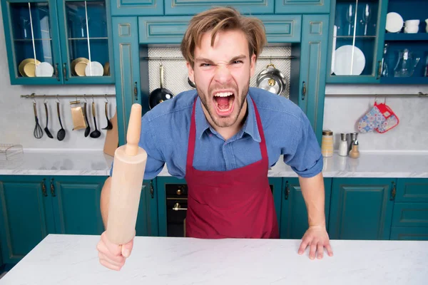 Man chef in apron shout with anger with rolling pin — Stock Photo, Image